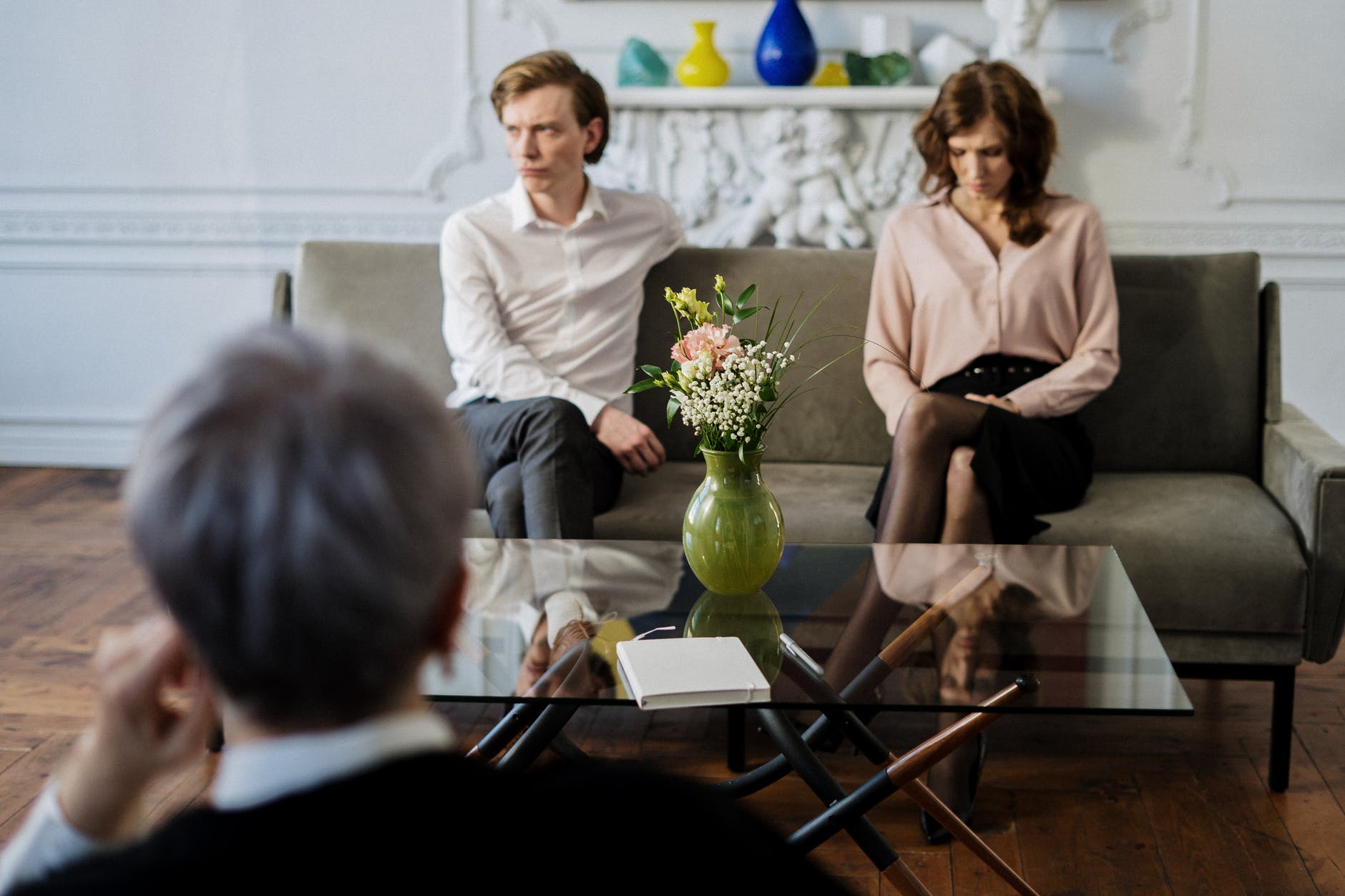 woman in white long sleeve shirt sitting beside woman in white long sleeve shirt