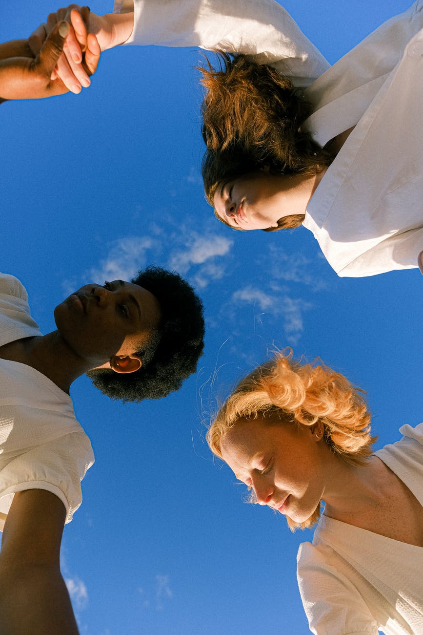 photo of women holding each other s hands