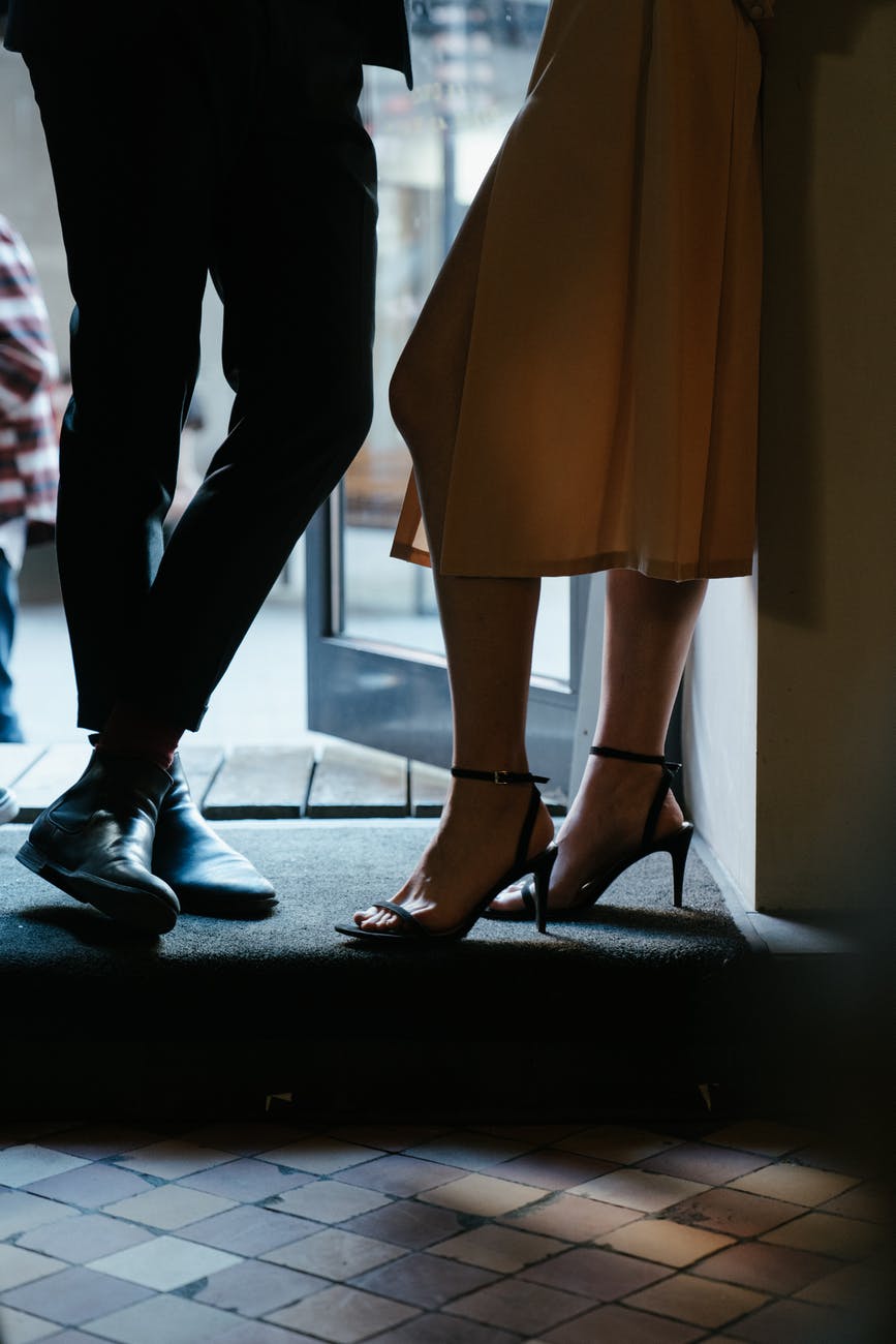 woman in brown dress and black leather shoes