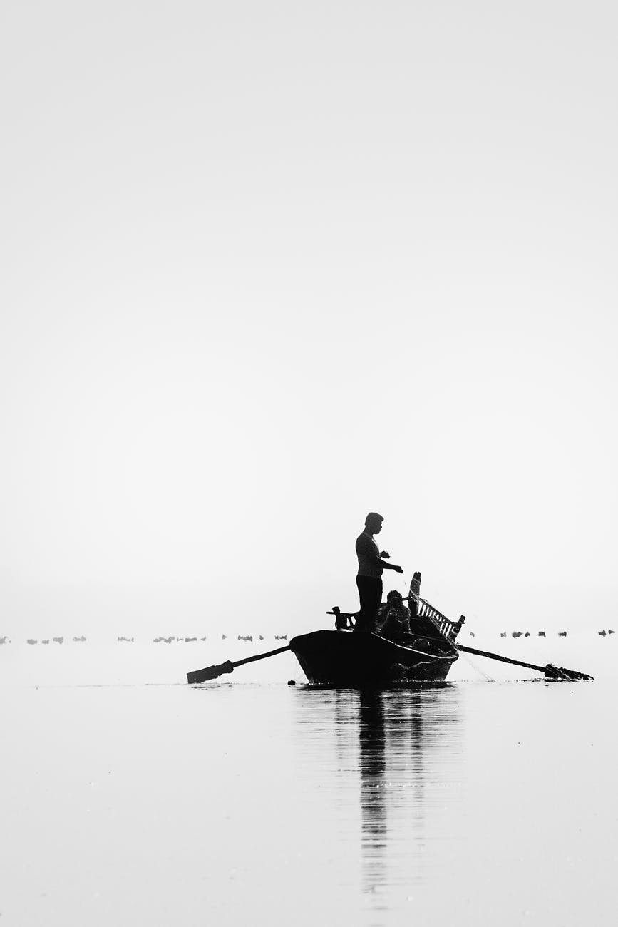 grayscale picture of two people go on fishing