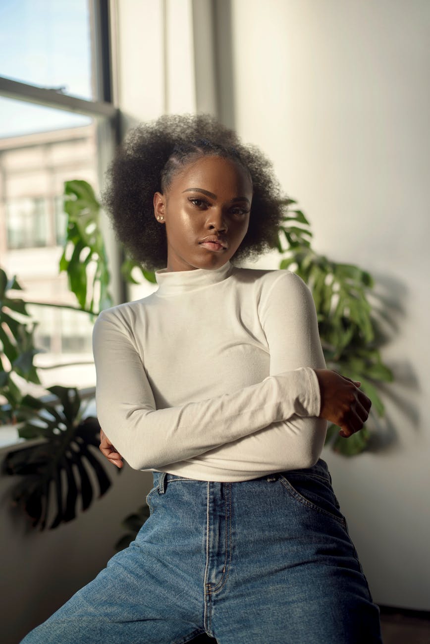 woman sitting near indoor plants