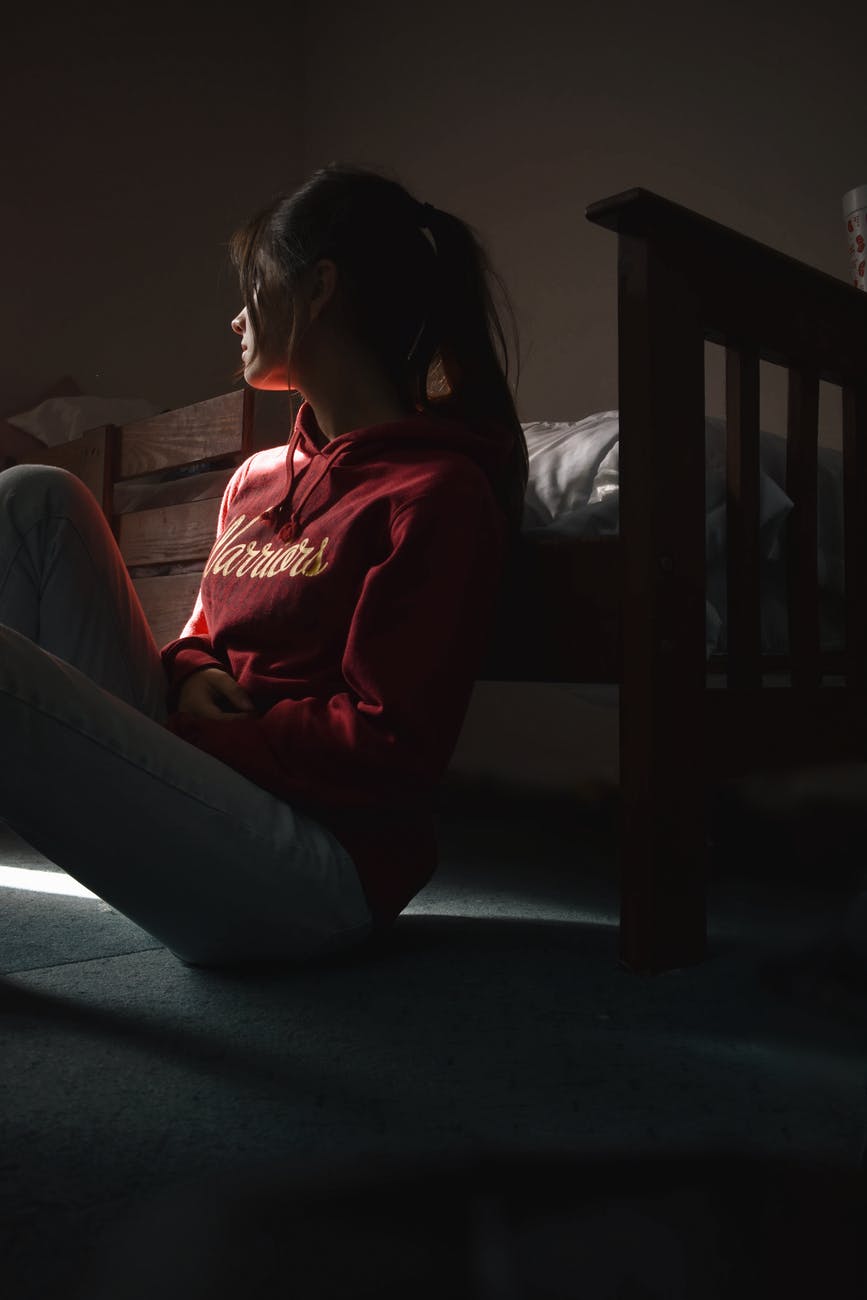 photo of woman sitting on floor