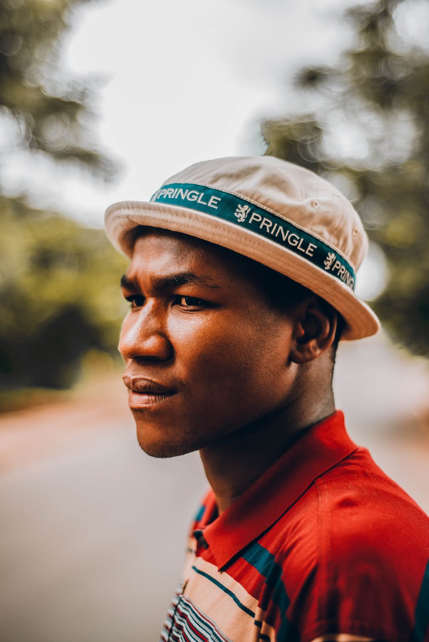 black confident man in hat on street