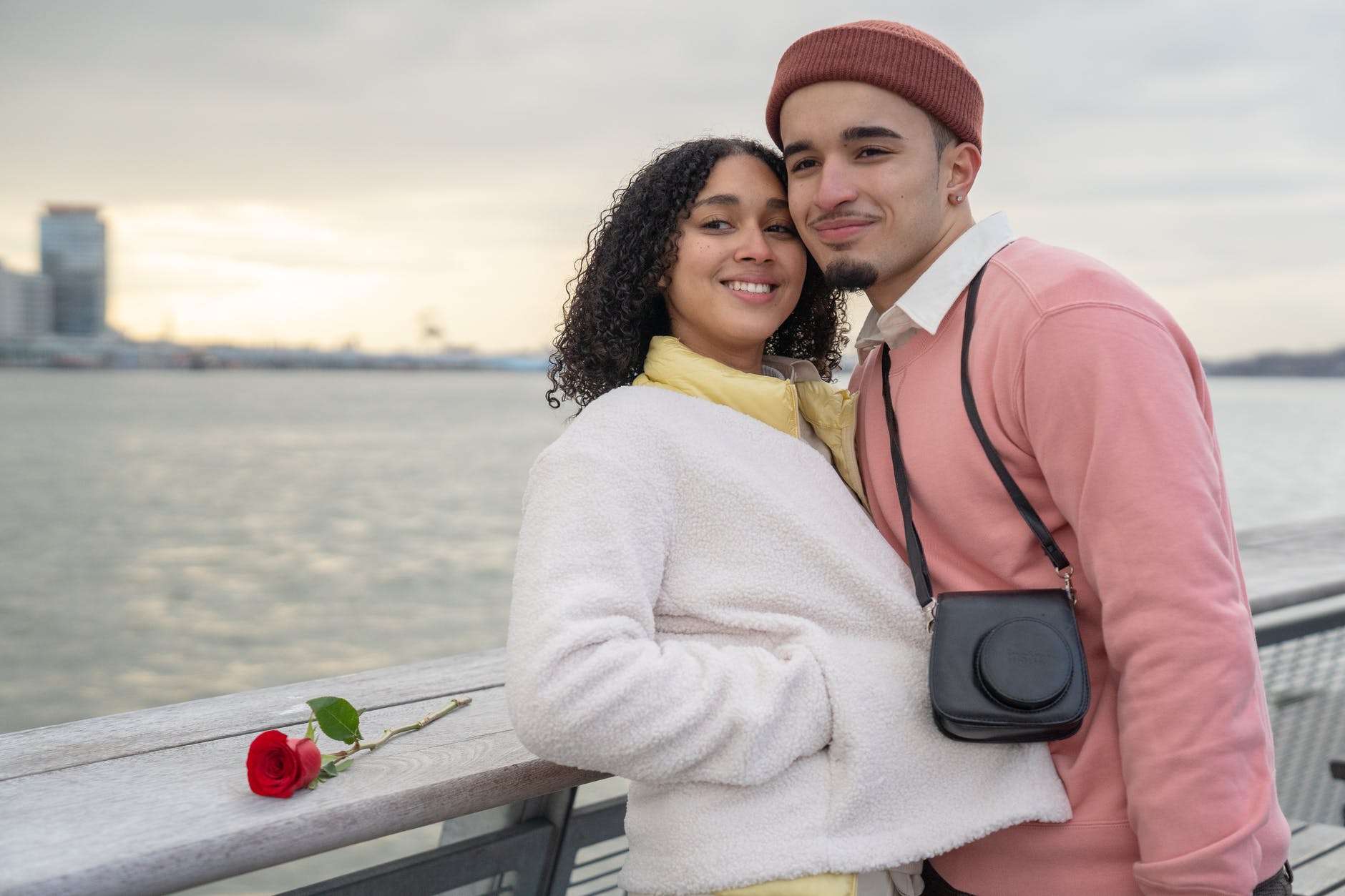 happy hispanic couple standing on embankment