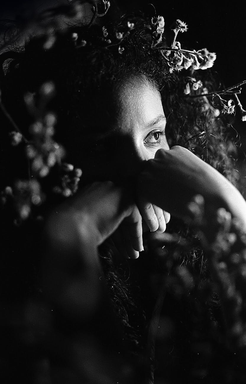 black woman surrounded with gentle flowers